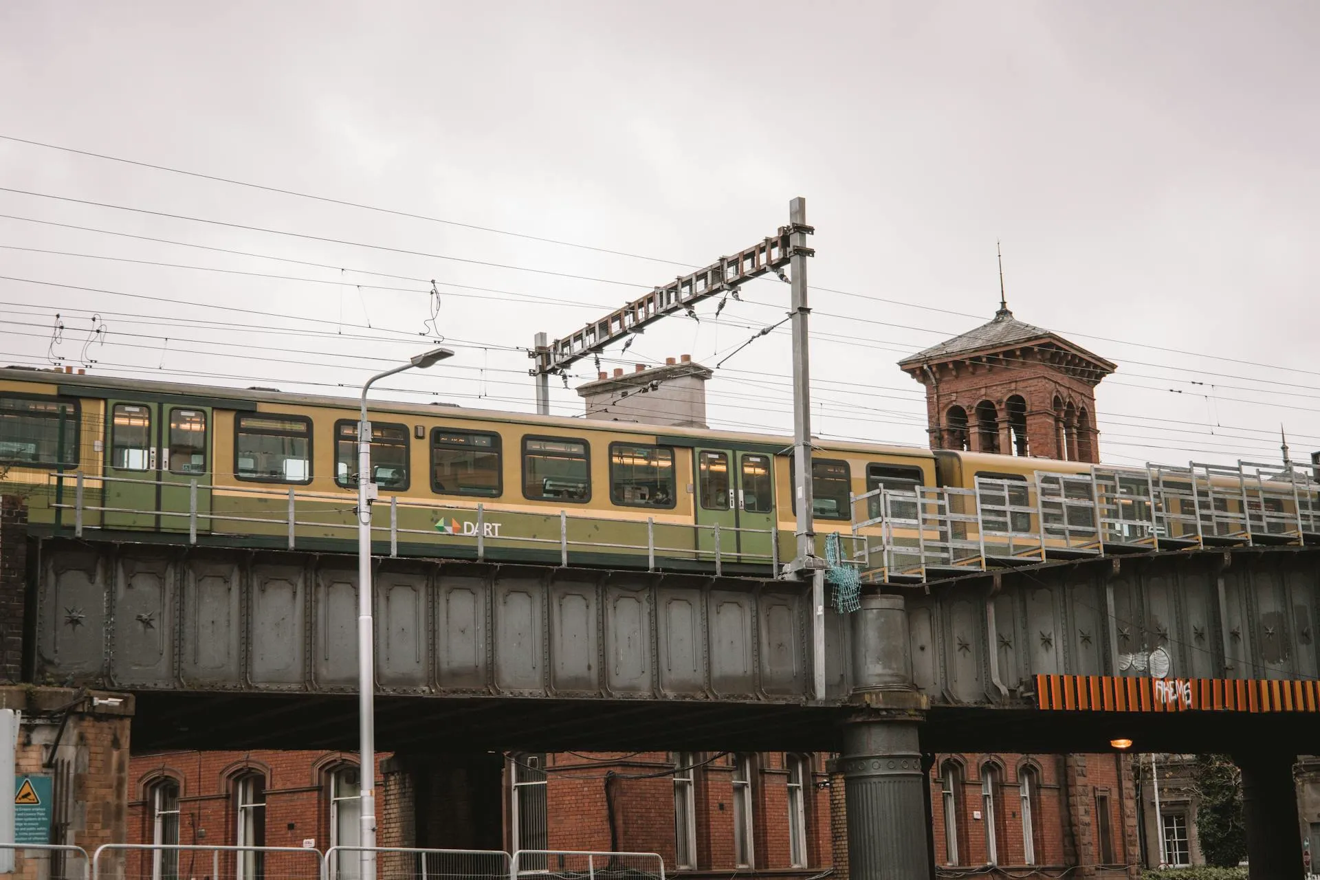 DART train crossing a red-brick railway bridge in Dublin