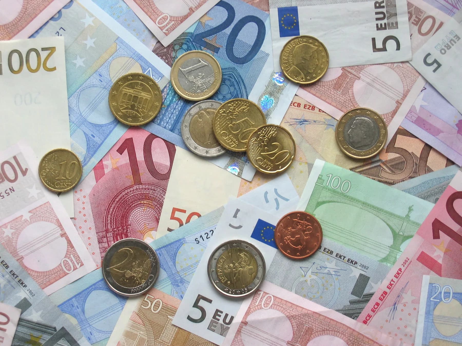A spread of euro banknotes and coins of several denominations