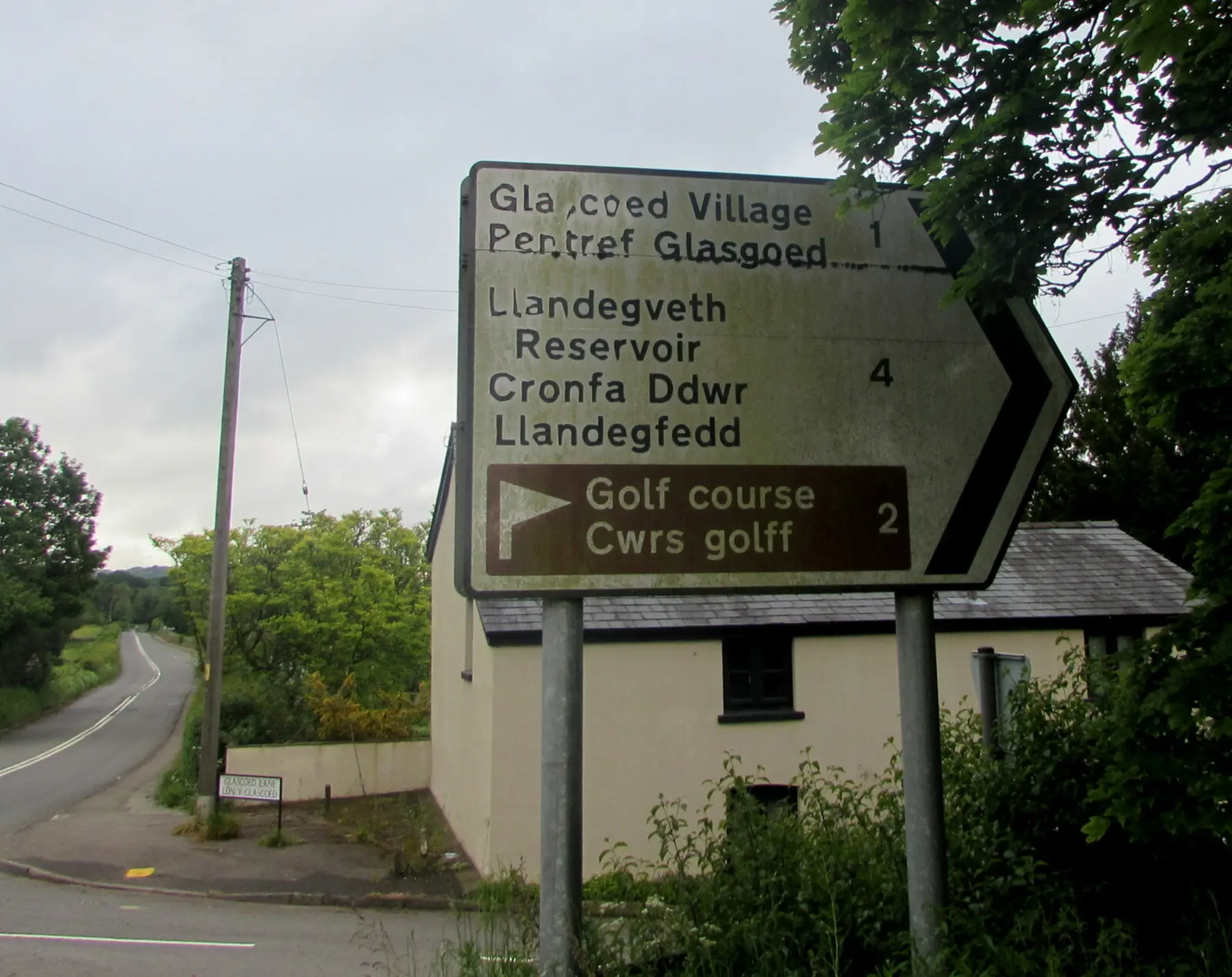 PLACEHOLDER: a bilingual road sign in Wales or the Scottish Highlands, source and verify before publish