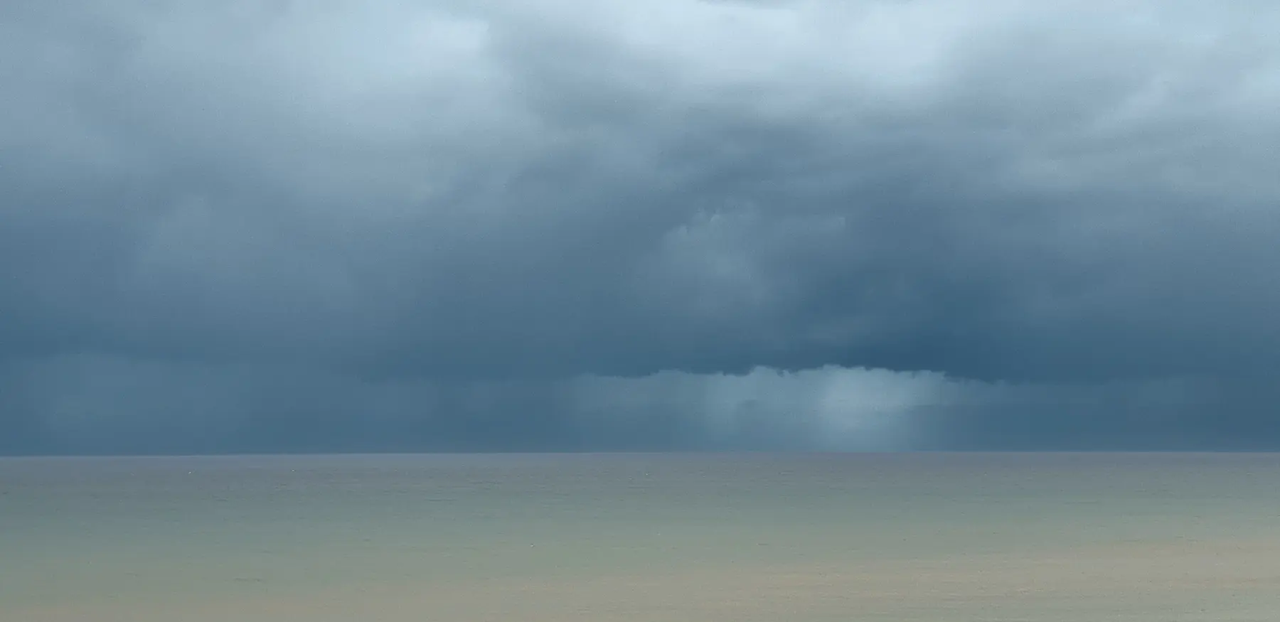 PLACEHOLDER: a dramatic changeable British sky over hills or coast, source and verify before publish